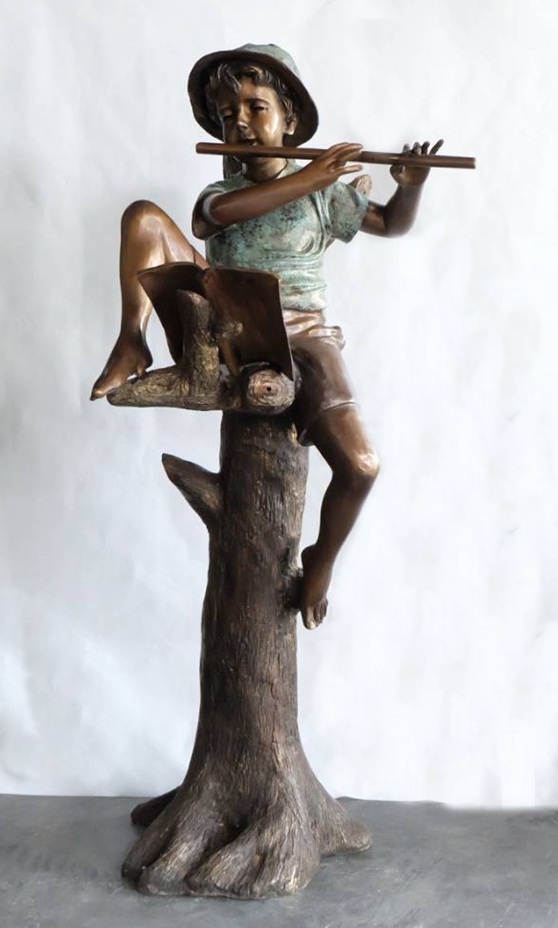 Boy on tree with flute